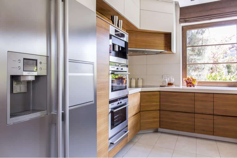 Photo of a modern kitchen with side by side refrigerator and wall oven