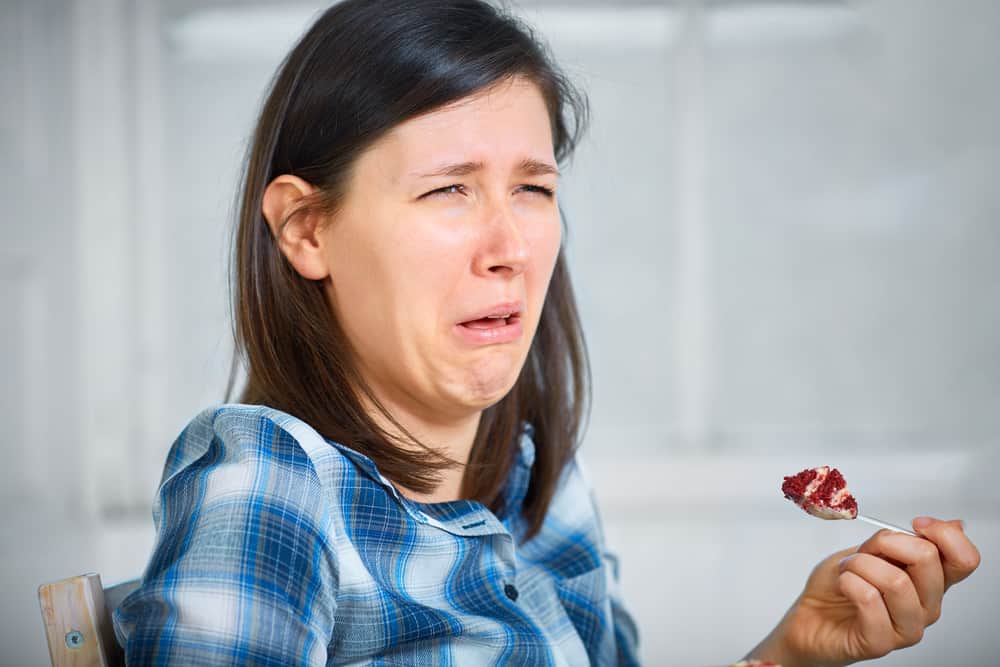 Photo of a woman eating bad tasting food