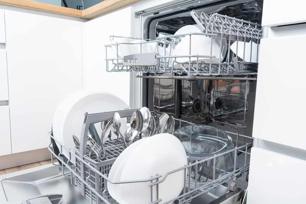 Photo of an open dishwasher with two dish racks