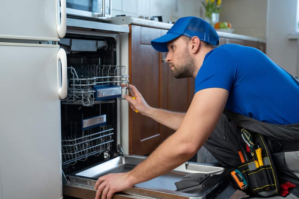 Photo of contractor looking at a dishwasher