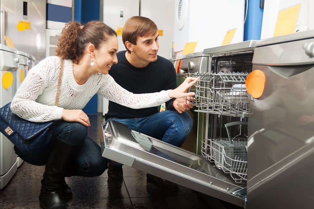 Photo of couple shopping for dishwasher in a big box store