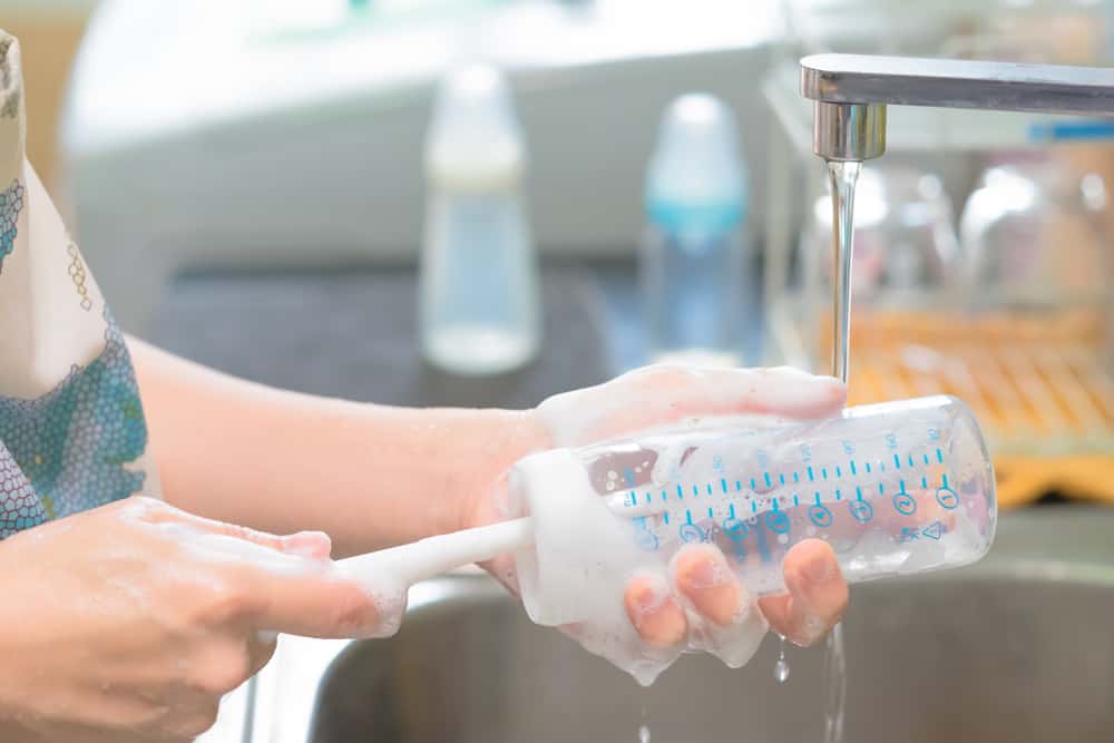 Photo of hand washing baby bottles