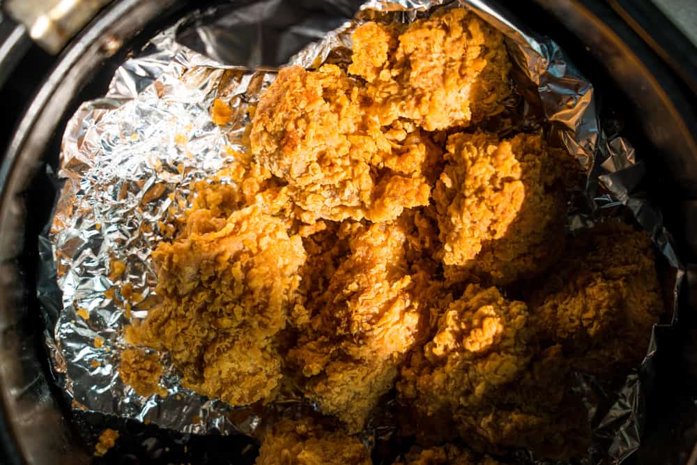 Photo of fried chicken on aluminum in an air fryer