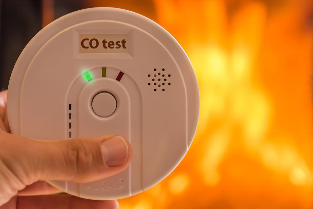 Photo of a Carbon Monoxide Detector with Flames in Background