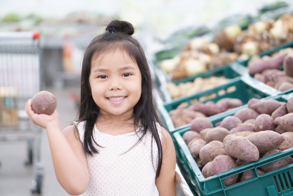 Photo of a girl holding a potato