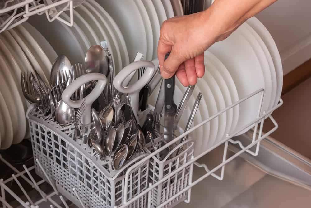 Photo of a knife being put in a dishwasher