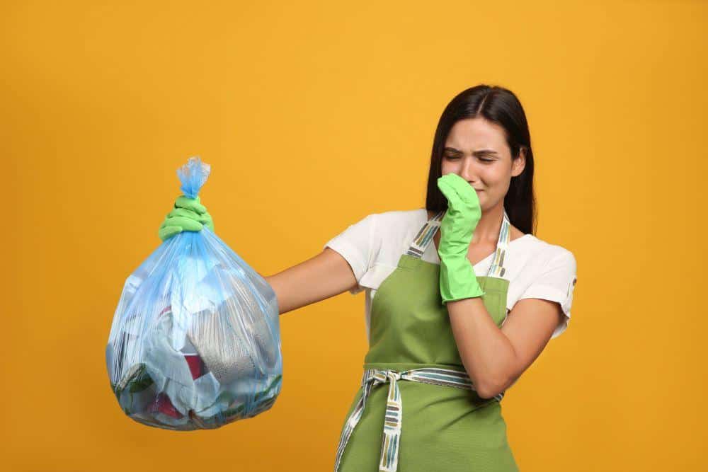 Photo of a Woman with a Stinky Trash Bag