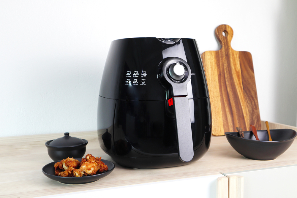 Photo of an air fryer on a wood countertop