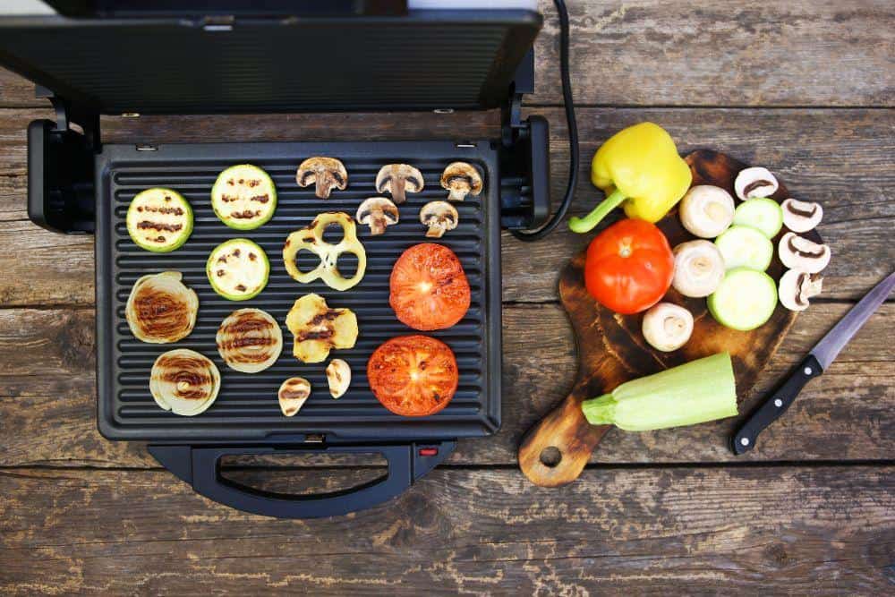 Photo of an Indoor Grill with Vegetables on Grill Plates