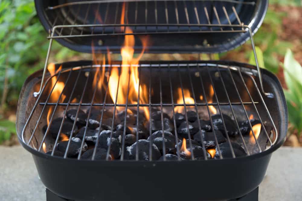 Photo of an open charcoal grill with flames