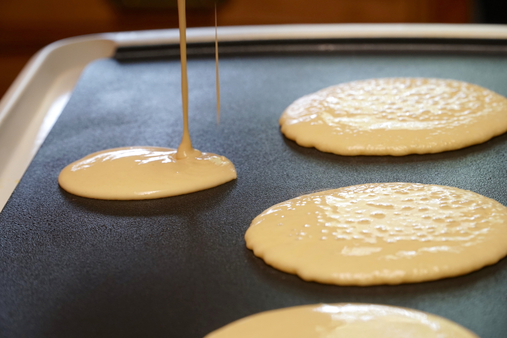 Photo of Pancake Batter Being Poured on a Griddle