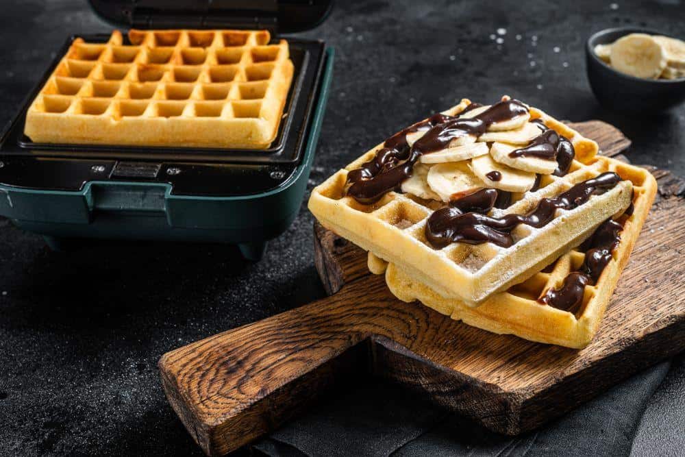Photo of waffles topped with bananas and chocolate