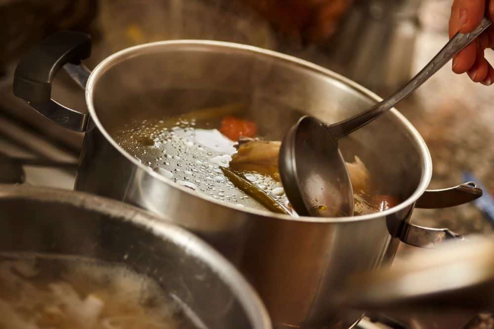 Photo of Someone Scooping Soup with a Ladle