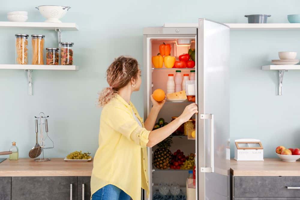 Photo of a Woman Opening a Refrigerator