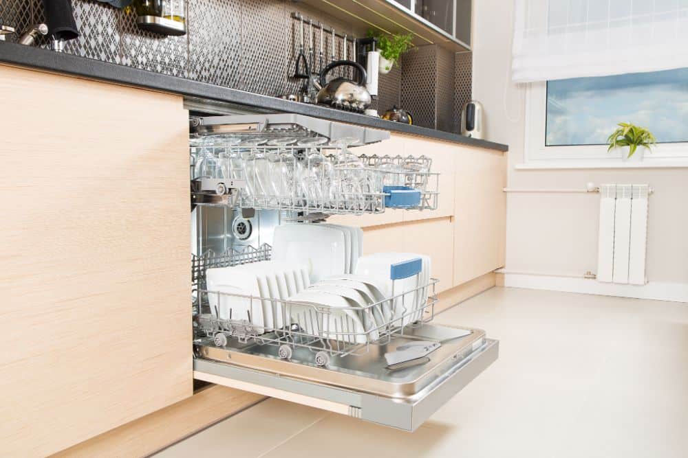 A dishwasher is open in a kitchen, indicating if plastic is dishwasher safe.