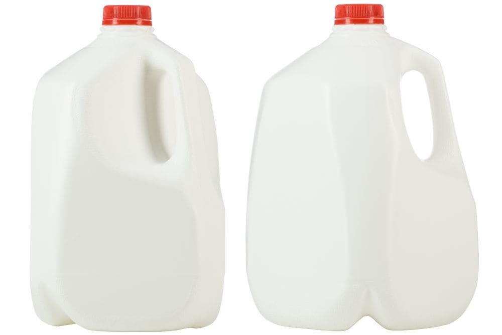Two white milk jugs on a white background with dishwasher safe plastic.