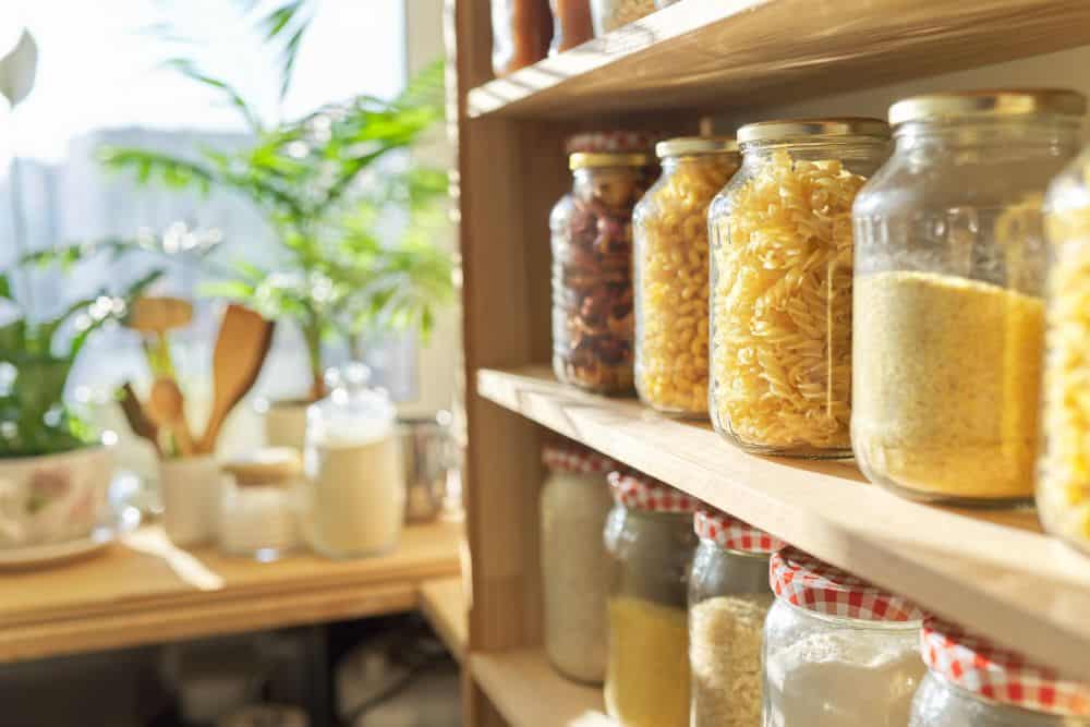 Food jars on kitchen shelf.