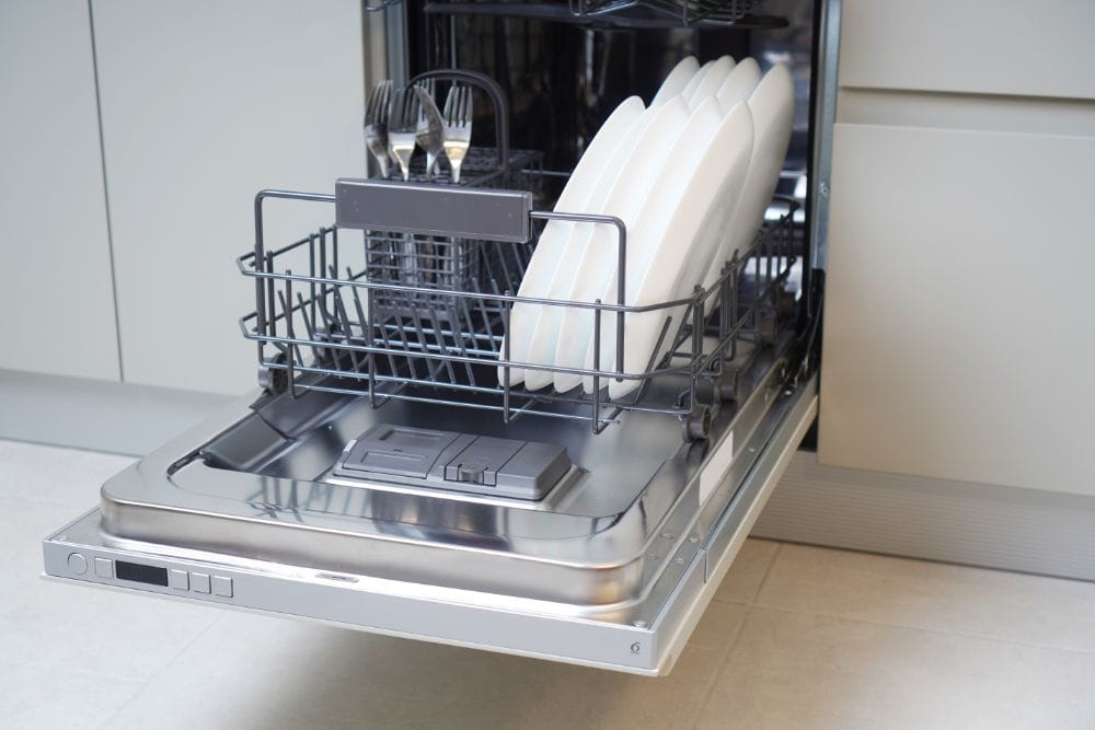 A paused dishwasher in a kitchen during a wash cycle.